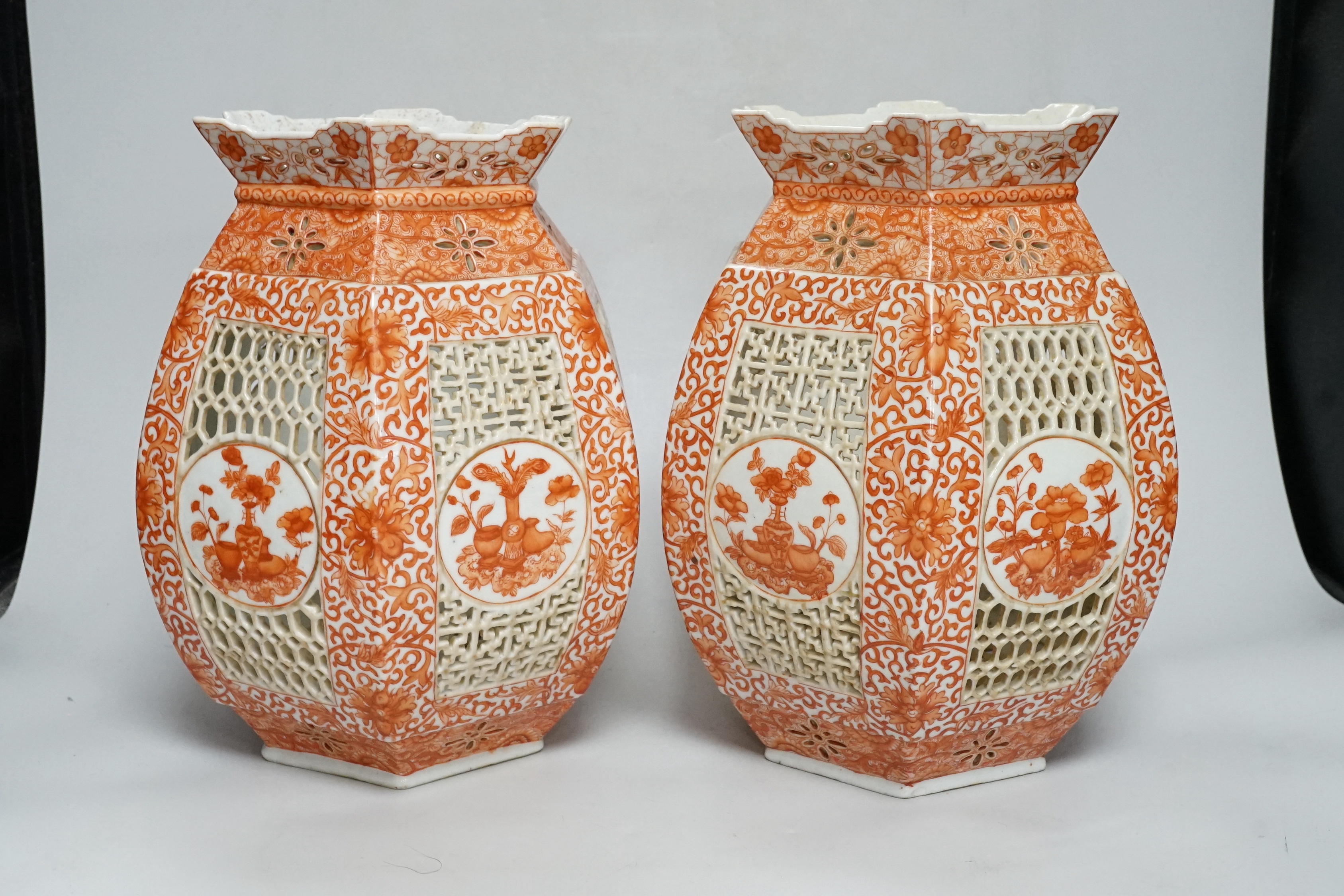 A pair of late 19th century Chinese reticulated and iron red enamelled lantern shades, 28cm